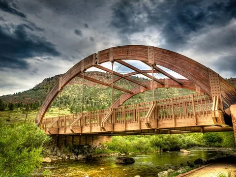 The wooden arch of the Apple Valley Road bridge over the North St. Vrain, the long float’s put-in, with the hogback behind