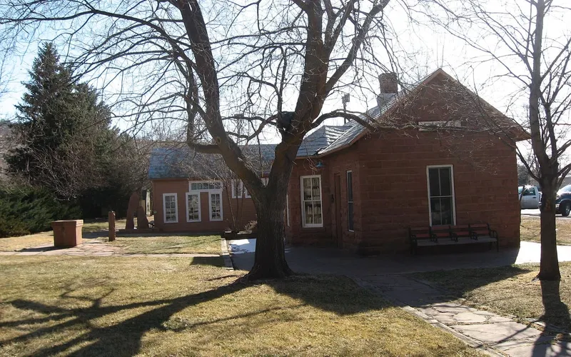 The old Lyons railroad depot in red sandstone, now the library building, under a clear sky