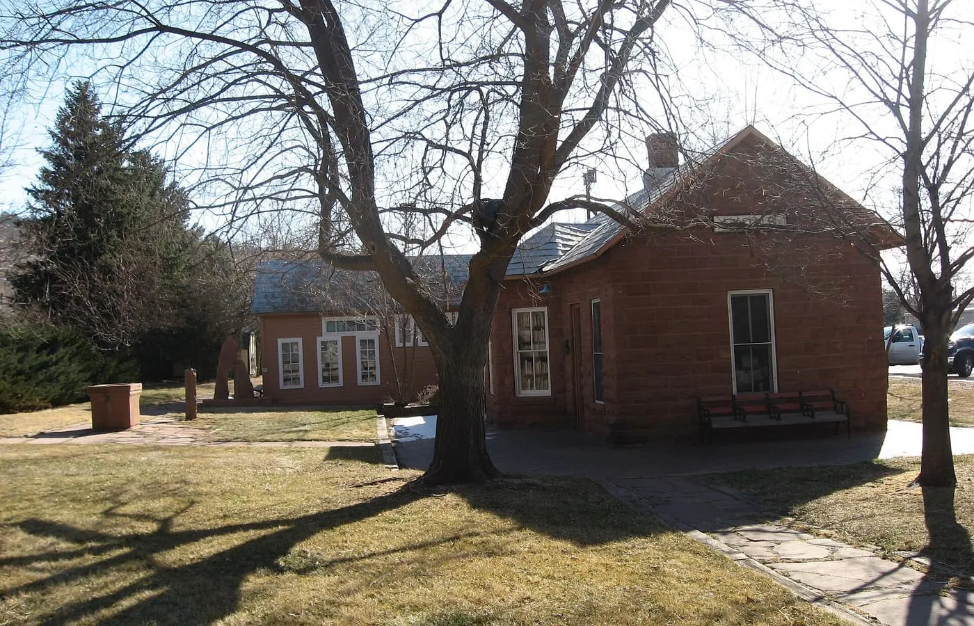 The old Lyons railroad depot in red sandstone, now Town offices and the Sheriff’s substation, under a clear sky